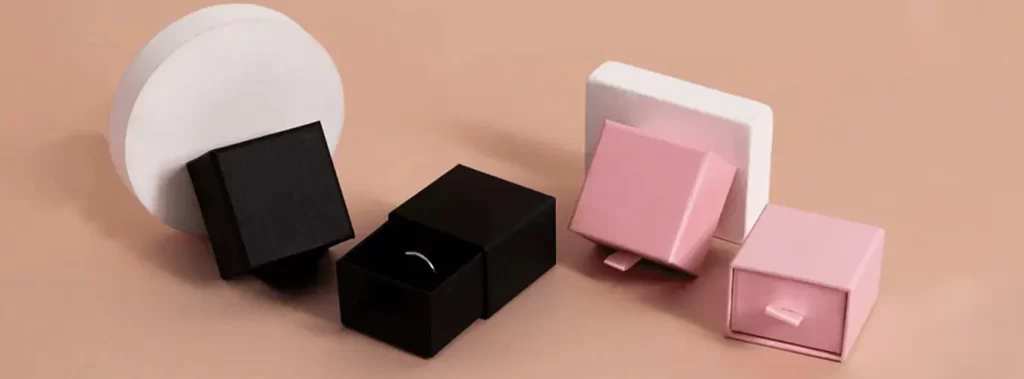 Three colored boxes stacked with a white box on top showcasing a variety of hues and textures in a neat arrangement